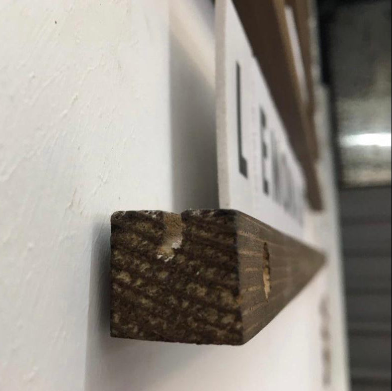 Ahşap menü panosunun harf yerleştirme kanallarının yakın çekim detayı.