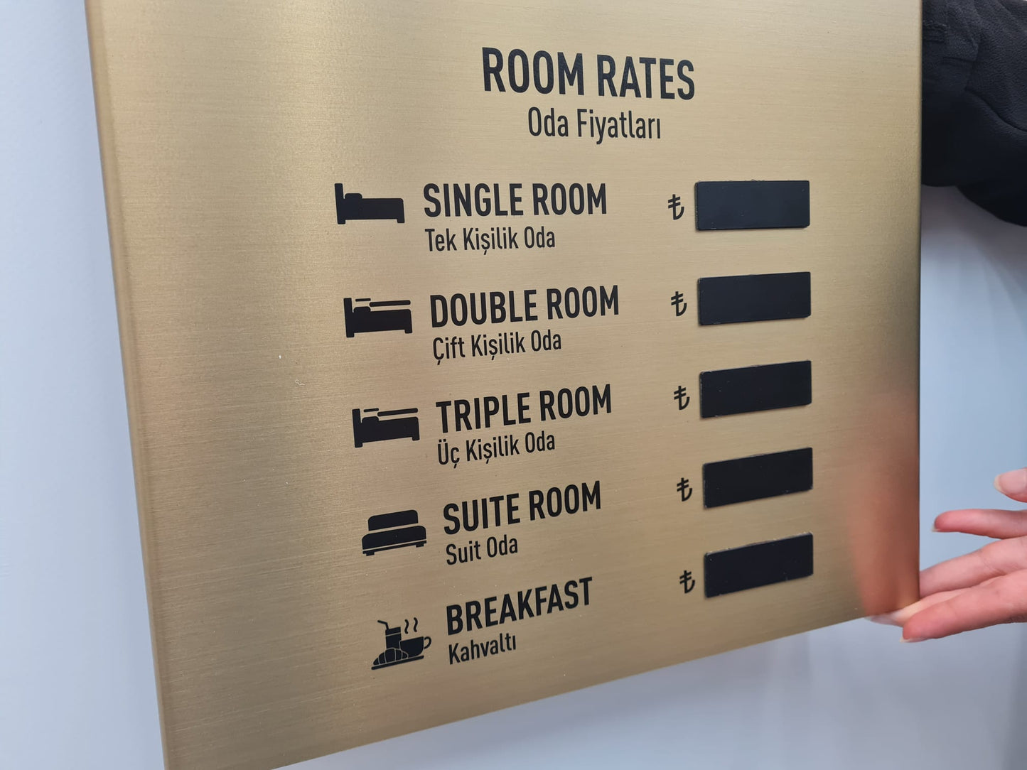 Gold renkli döviz panosu, otel lobisinde duvara monte edilmiş, şık ve prestijli görünüm.