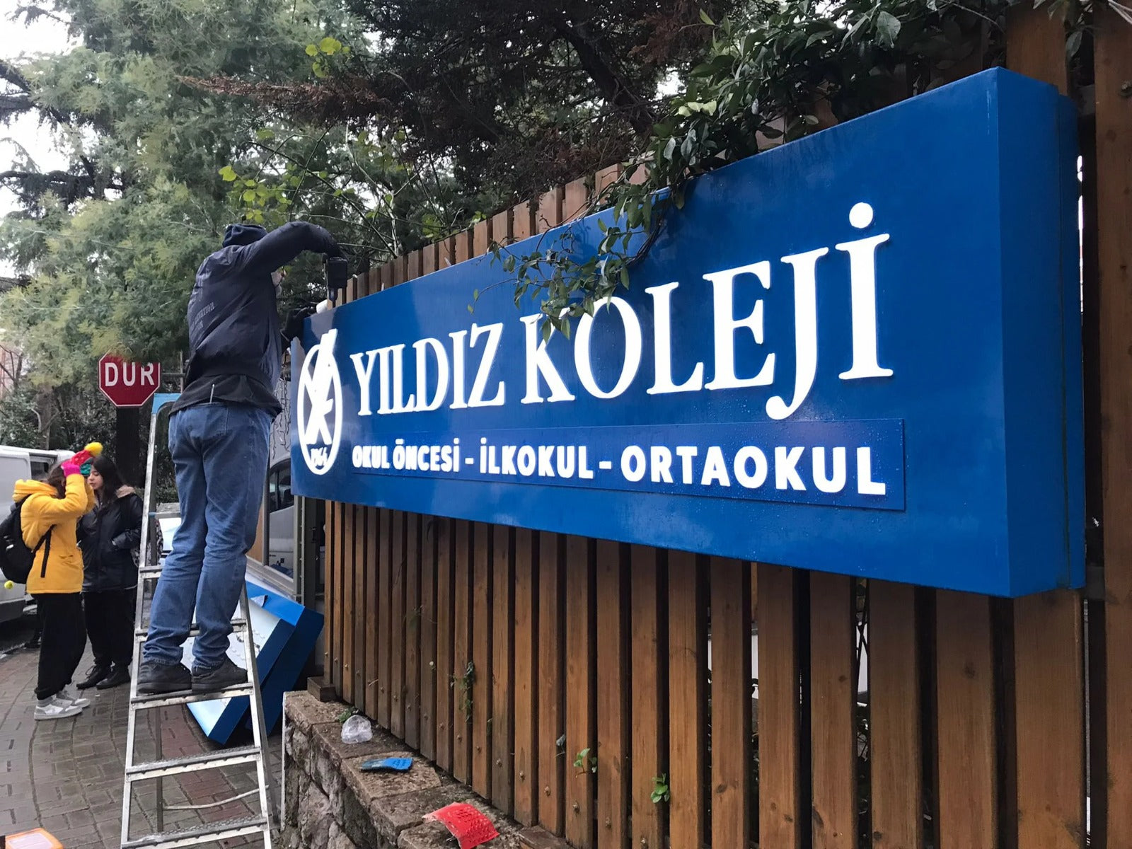 Kurumsal bina cephe isimlik tabelası, dairesel formda ışıklı marka uygulaması.